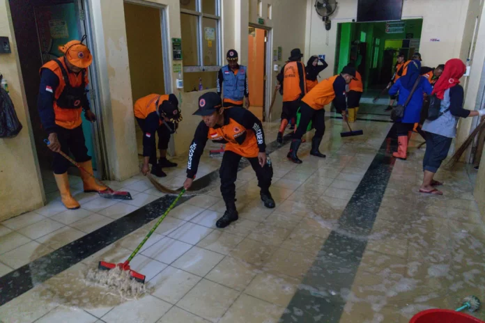 Pasca banjir Tim Gabungan dari semua unsur bersama-sama membersihkan fasum di Dusun Karanganayar, Kecamatan Karanganyar, Selasa (20/2). (Bidang Komunikasi Kebencanaan/Andhika Rivaldi)